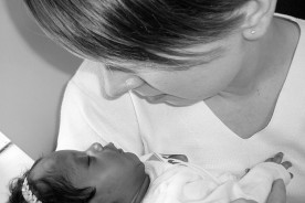an adopted baby with its adoptive mother